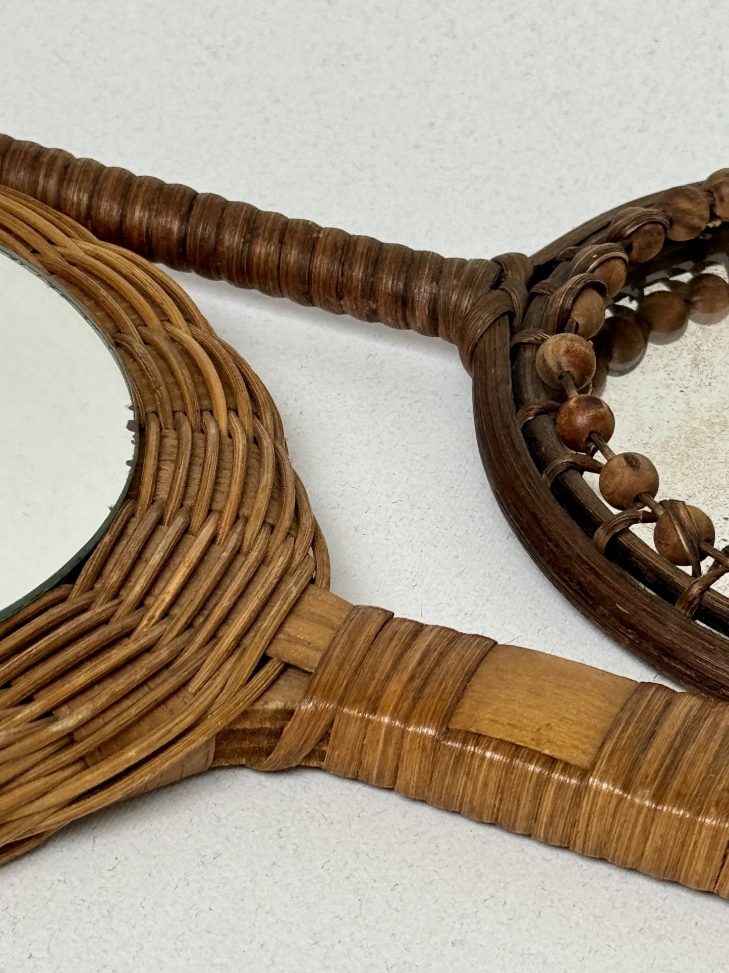 Coppia specchi a mano in rattan – dettaglio cornice a palline intrecciate e specchio con patina d'epoca